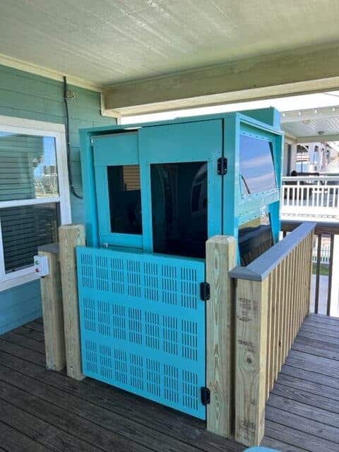 Blue passenger compliant outdoor elevator with open work gate with interlock